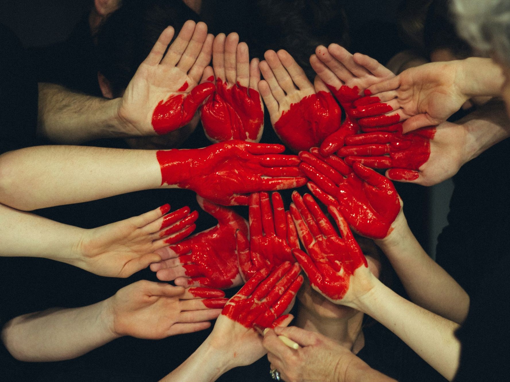 A group of volunteers with painted hands joined together